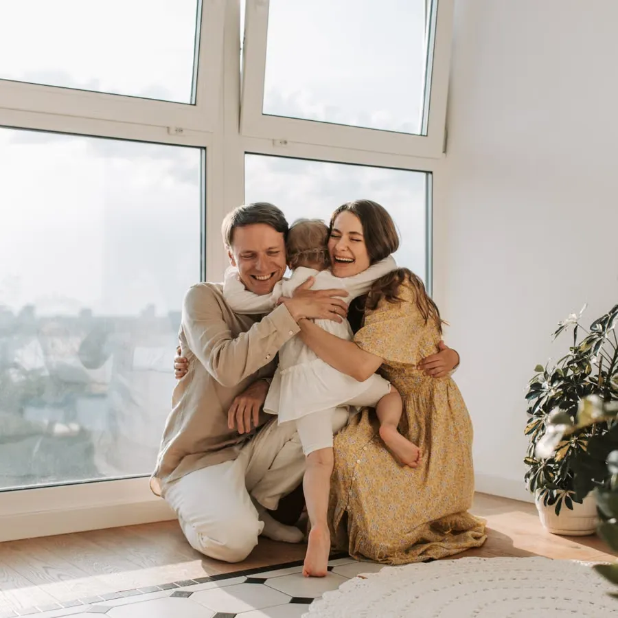 A family embracing near a window
